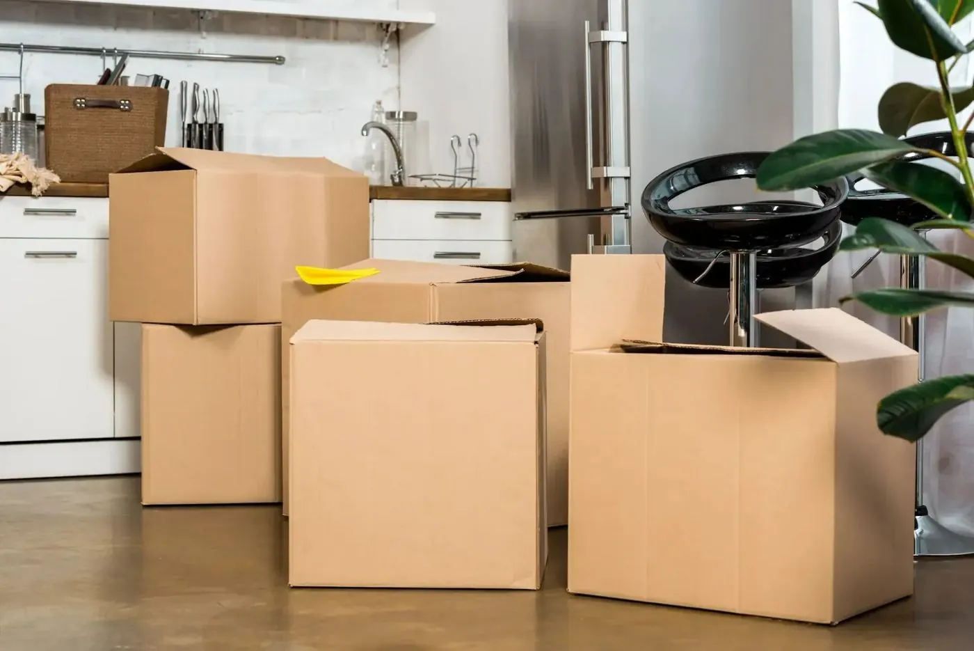 Packed moving boxes in a kitchen being cleared out before a remodel