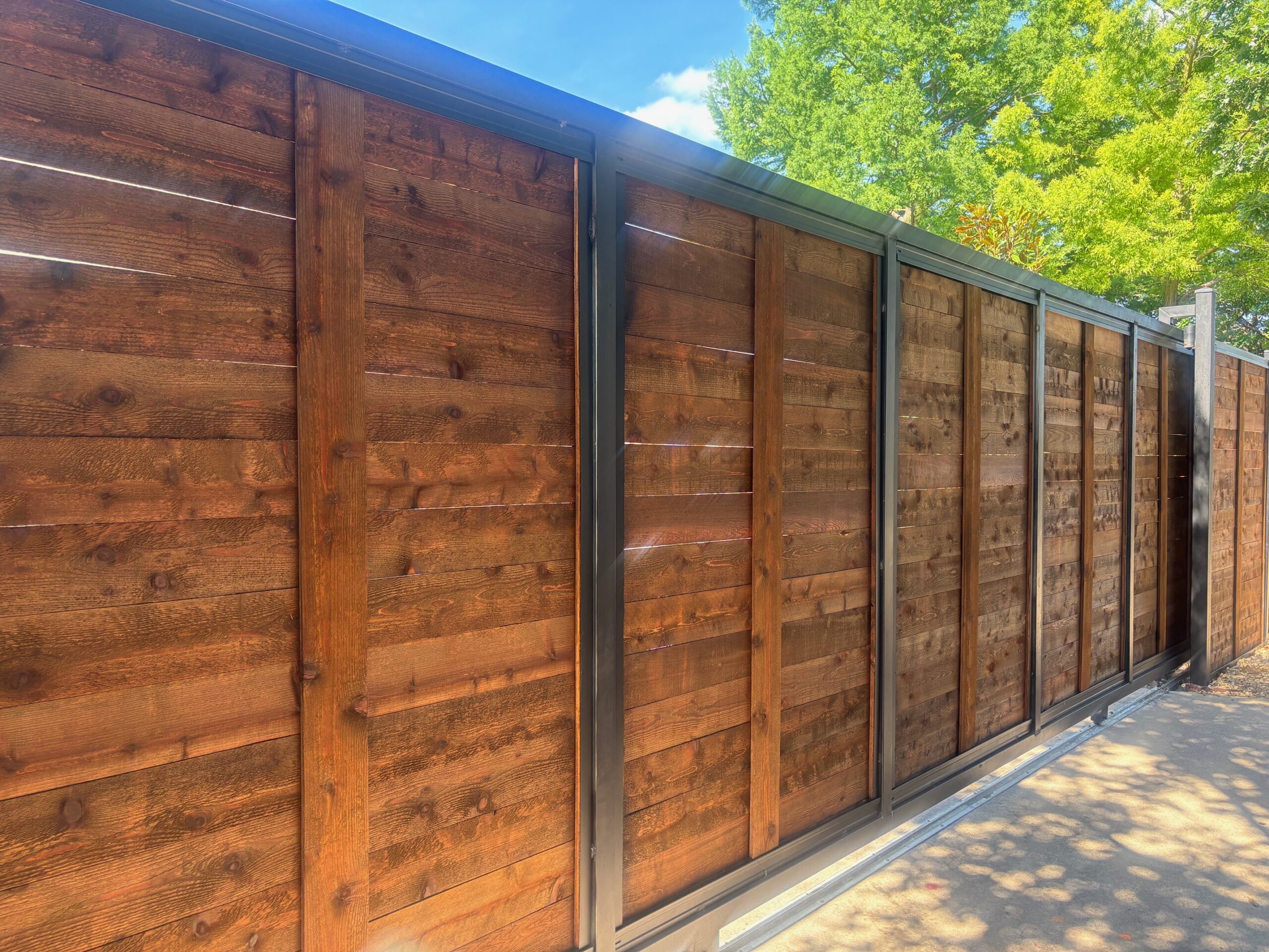 Custom automatic sliding gate on a driveway fence project