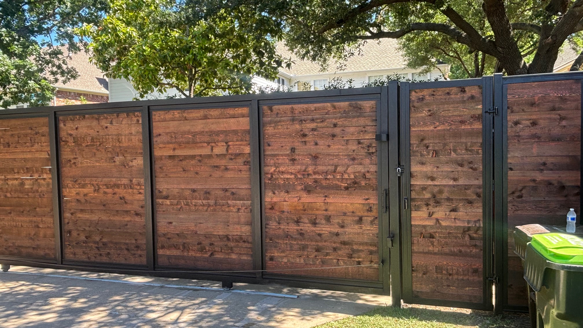 Custom automatic sliding gate with tracked fence, a specialty fence project