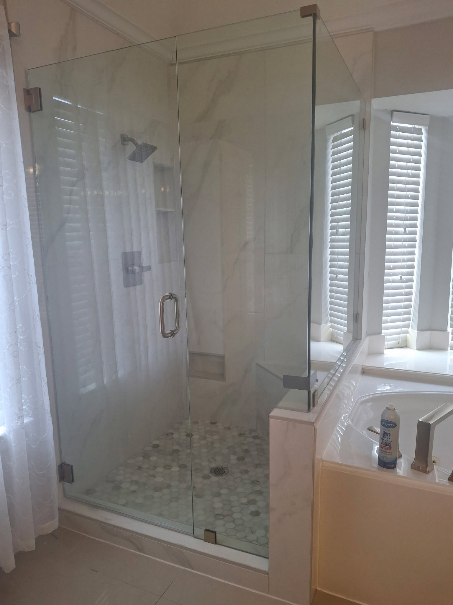 Bathroom remodel with a frameless glass shower enclosure