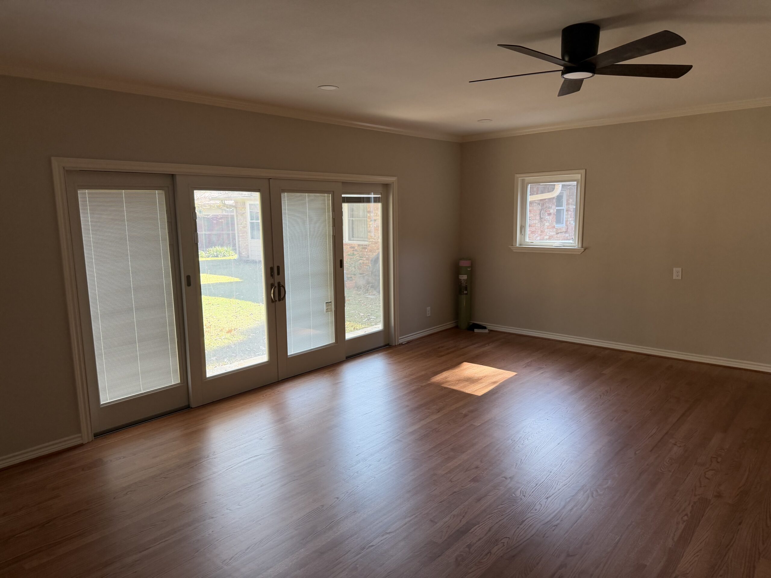 Room addition with engineered hardwood flooring and custom doors