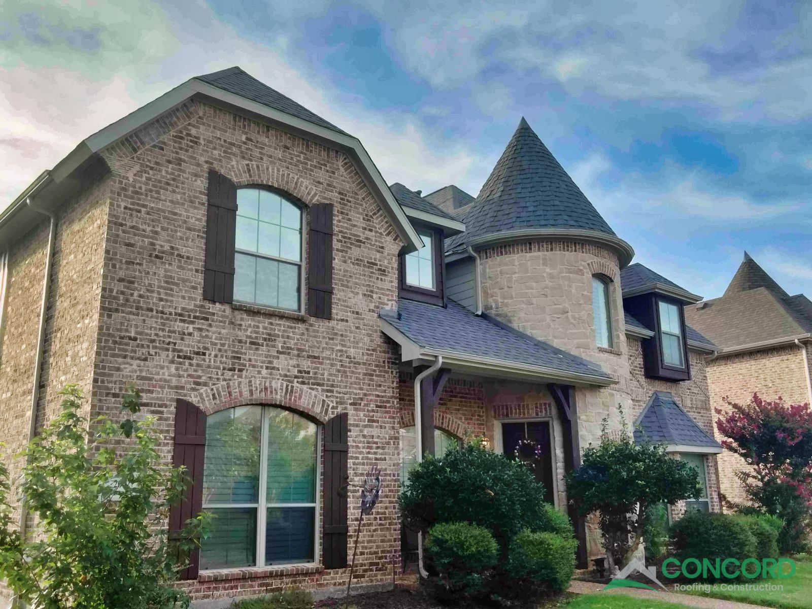 Finished roof replacement with Class 4 impact-resistant shingles and new gutters on a brick and stone home in Allen, TX