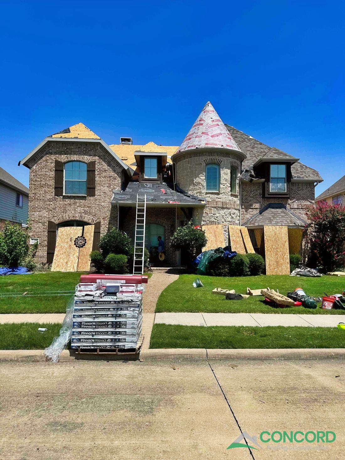 Allen, TX home mid roof replacement with new underlayment and Atlas Pinnacle Impact shingles partially installed, and the shingle pallet out front