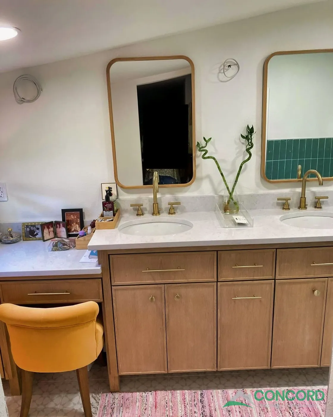 Double vanity with two sinks, brass faucets, and gold-framed mirrors, with a makeup desk at the end, in a remodeled Dallas, TX bathroom