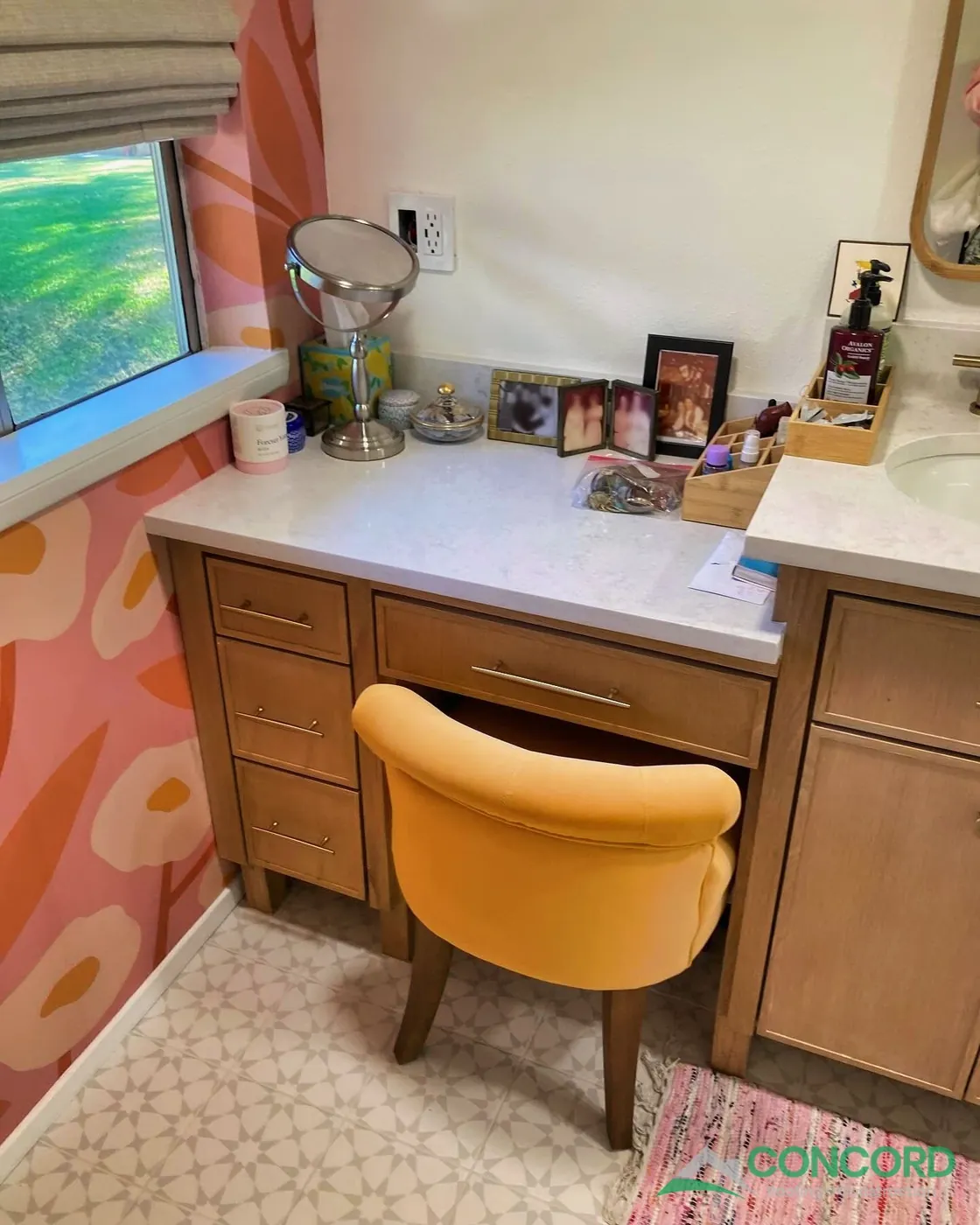 Makeup desk with drawers and a yellow chair beside the vanity in a remodeled Dallas, TX bathroom