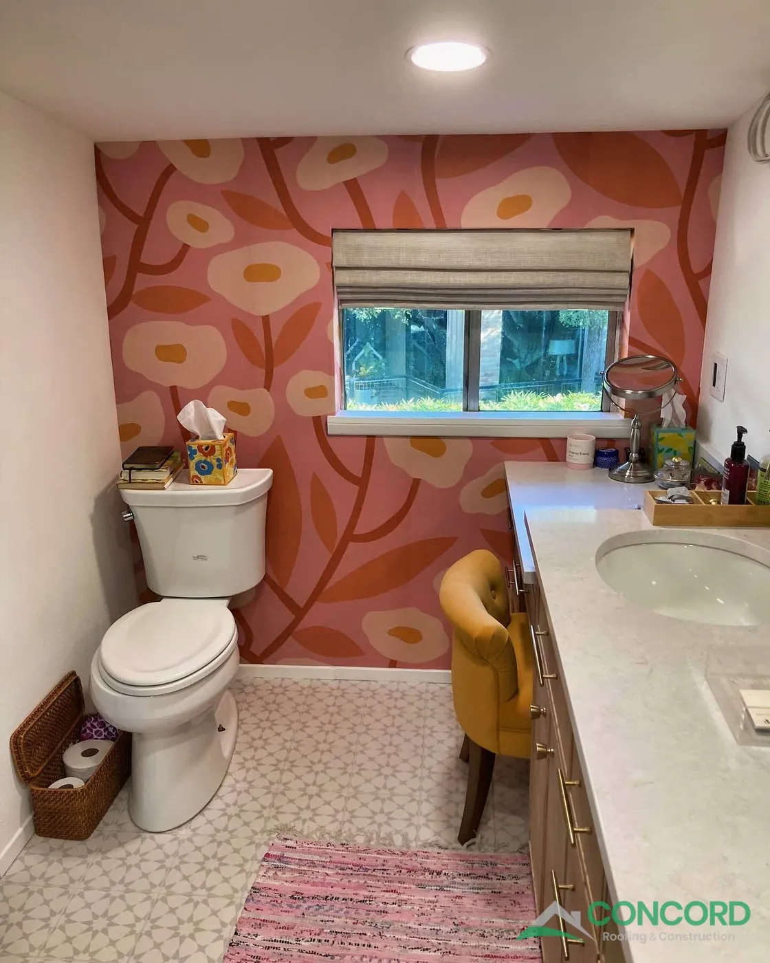 Floral wallpaper accent wall behind the toilet, with new patterned floor tile and the vanity, in a remodeled Dallas, TX bathroom