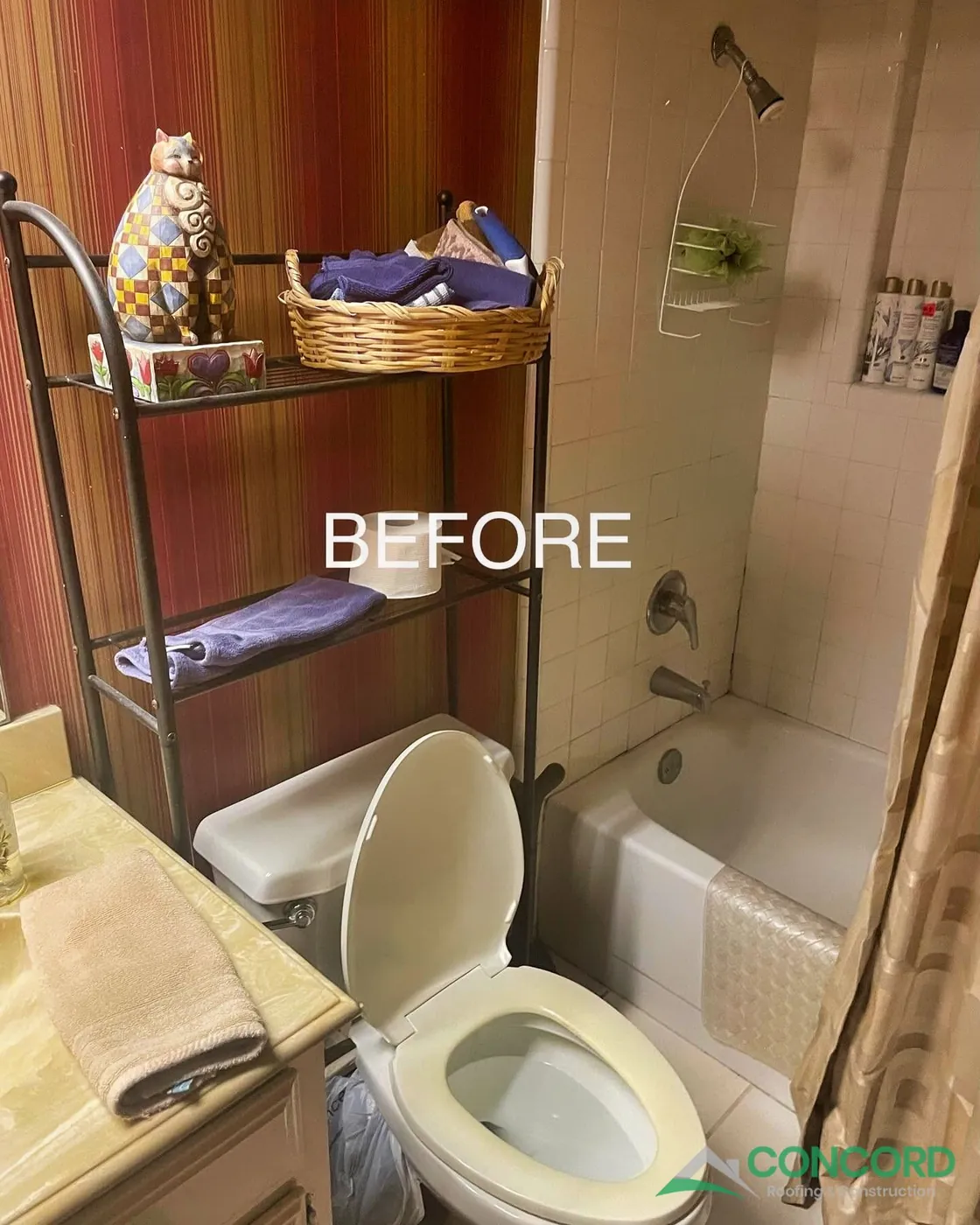 Dallas, TX hall bathroom before the remodel, with an older tub and tile surround, a toilet with a shelf unit above it, and red striped walls
