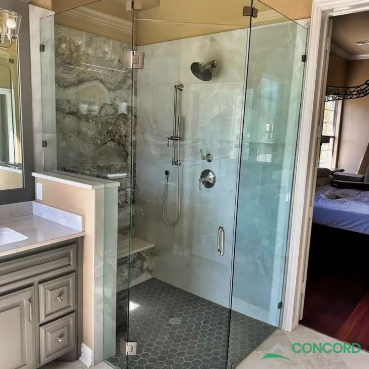 Remodeled master bathroom shower in Frisco, TX with new tile and a glass enclosure