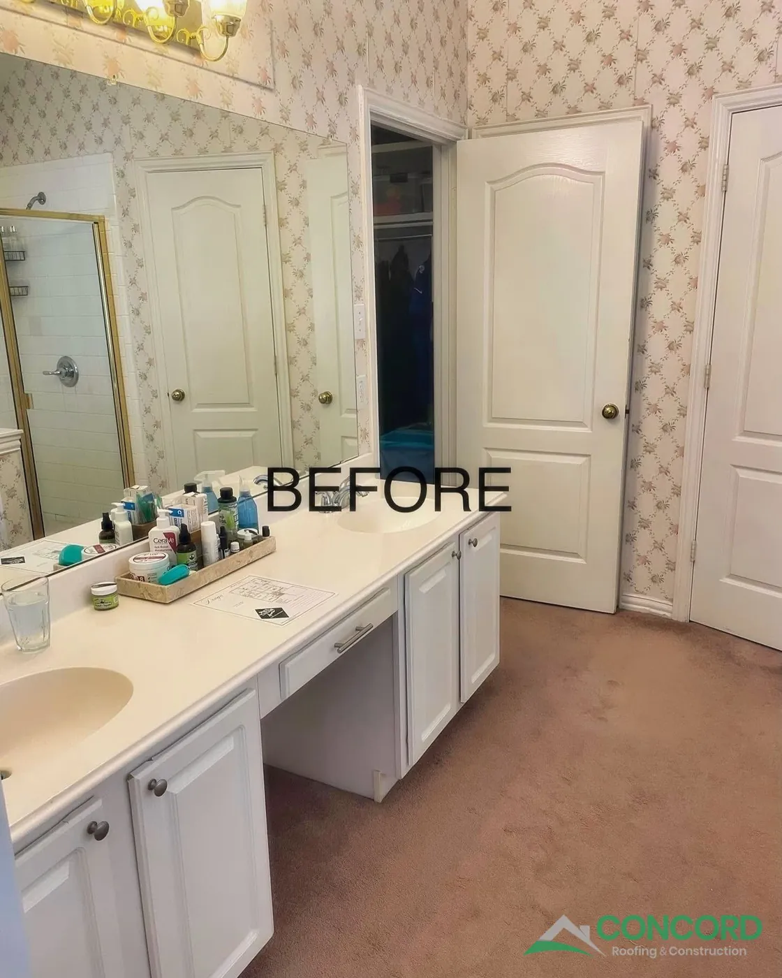 McKinney, TX master bathroom before the remodel, with floral wallpaper, carpet, and an older vanity