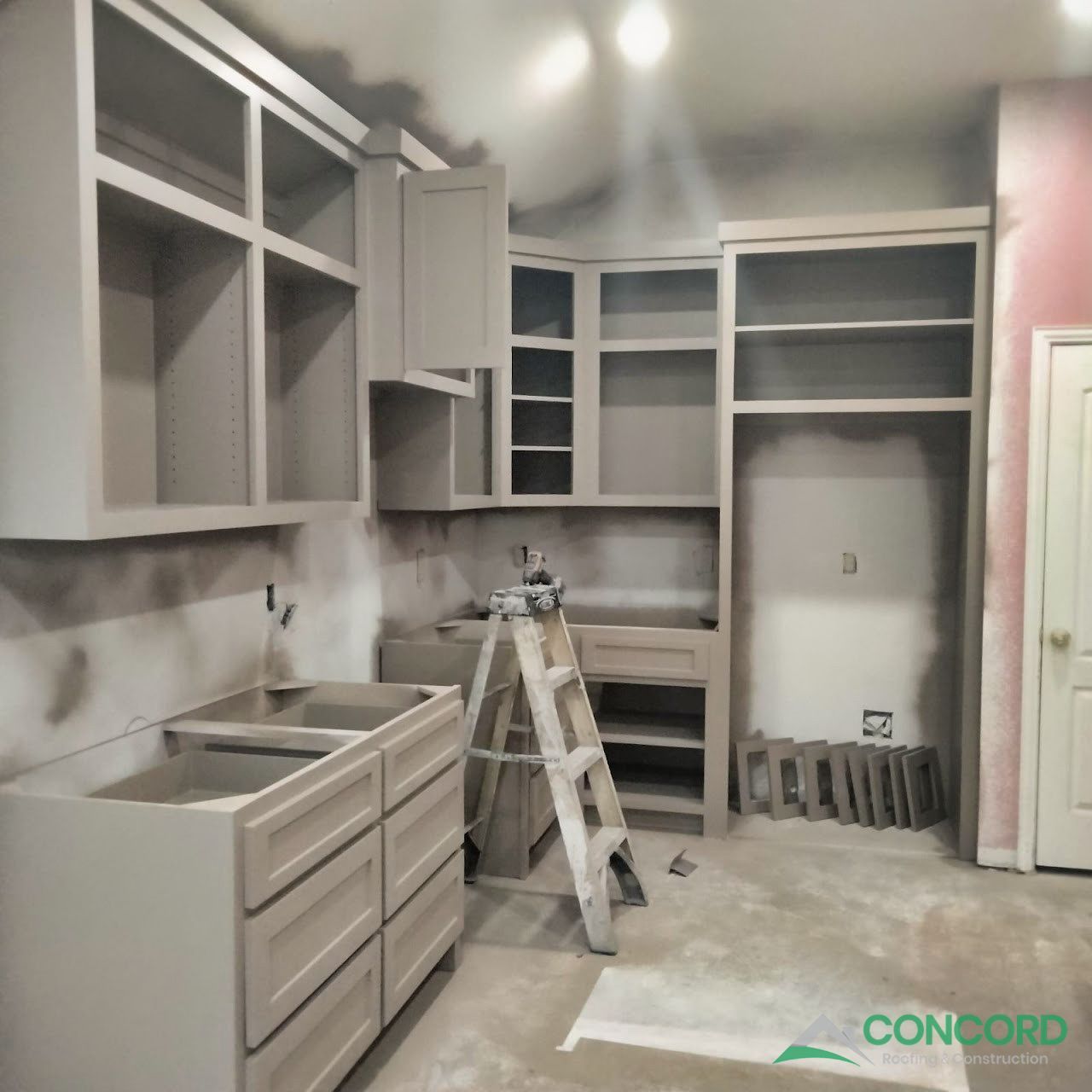 New kitchen cabinets being spray-painted in place during a McKinney kitchen remodel
