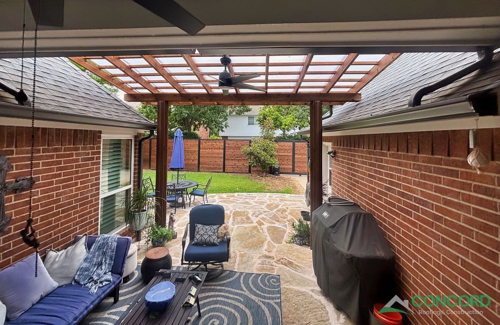 Finished horizontal wood privacy fence seen from the back patio of a Plano home