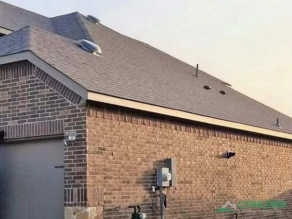 Finished roof with new IKO Cambridge architectural shingles and matching ridge on a brick home in Princeton, TX
