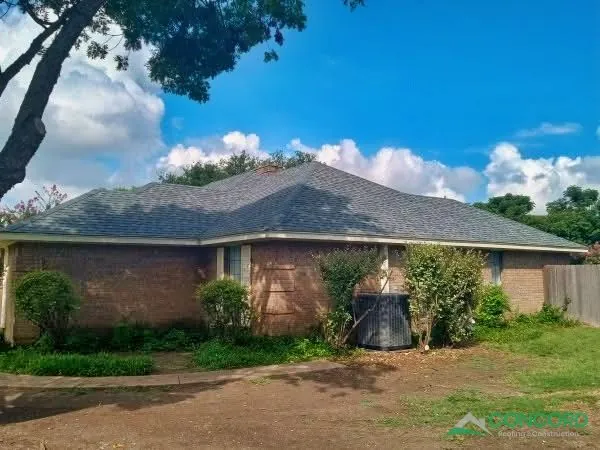 New shingle roof on the side of a single-story brick home in Waxahachie, TX