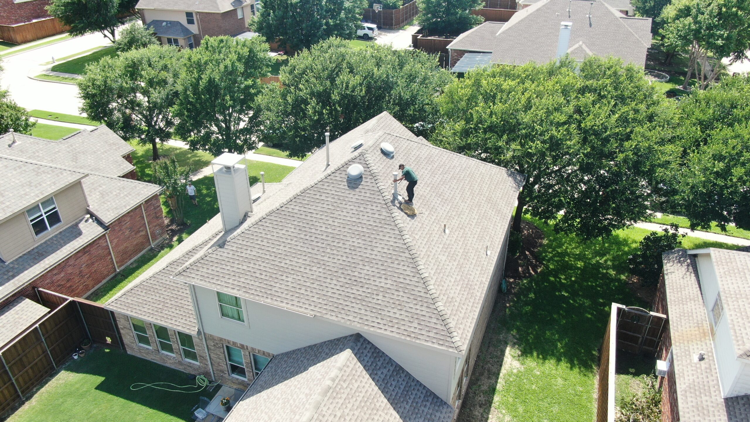 Concord Roofing crew finishing a residential asphalt shingle roof installation